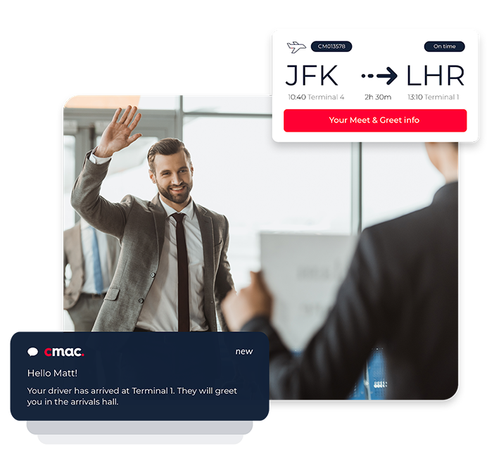A man in a gey suit waving at a person at a check-in desk in an airport
